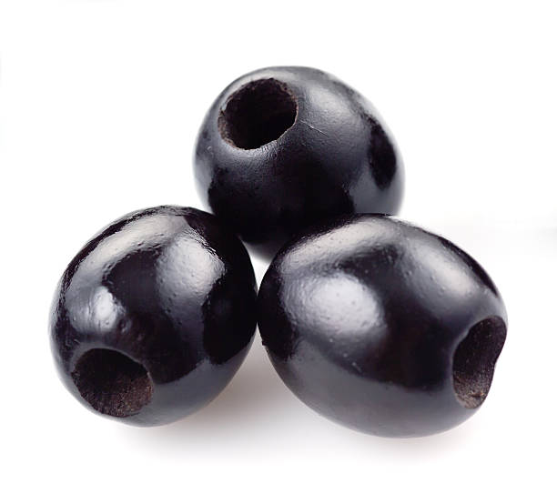 three black olives isolated on white